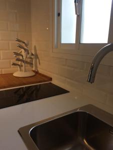 a kitchen sink with a faucet next to a window at Casa Aldea de la Gitana in Estepona