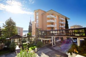 an apartment building with a balcony and a bridge at Hotel Neptun - Terme & Wellness LifeClass in Portorož