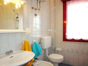 a bathroom with a toilet and a sink at Gabbiano Atlante in Bibione