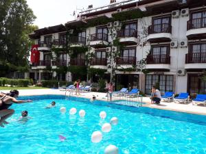a group of people playing in a swimming pool at Hamle Hotel in Akyaka