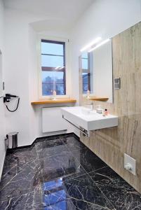 a bathroom with a sink and a mirror at Hotel Am Markt in Oebisfelde