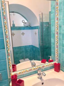 a bathroom with a sink and a mirror at Casa Rosetta in Praiano +81 photos