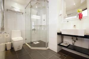 a bathroom with a shower and a toilet and a sink at Taitung Yes Hotel in Taitung City