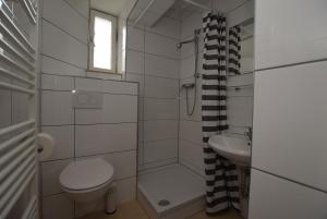 a small bathroom with a toilet and a sink at Apartment Stuttgart Ost in Stuttgart