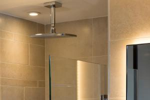 a bathroom with a shower and a light fixture at Hotel Le 10 BIS in Paris +31 photos