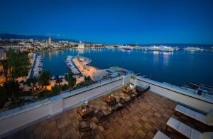 a balcony with a view of a harbor and the water at Belvedere Luxury Rooms - Breathtaking View in Split