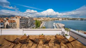 a balcony with chairs and a view of the water at Belvedere Luxury Rooms - Breathtaking View in Split