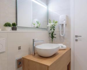 a bathroom with a white bowl sink on a wooden counter at Belvedere Luxury Rooms - Breathtaking View in Split