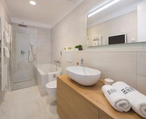 a white bathroom with a sink and a toilet at Belvedere Luxury Rooms - Breathtaking View in Split