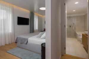 a bedroom with a bed and a bathroom with a shower at Belvedere Luxury Rooms - Breathtaking View in Split