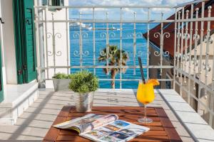 a balcony with a table and a glass of orange juice at Belvedere Luxury Rooms - Breathtaking View in Split