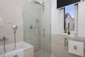 a bathroom with a shower with a glass door at Belvedere Luxury Rooms - Breathtaking View in Split