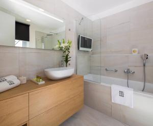 a bathroom with a sink and a tub and a shower at Belvedere Luxury Rooms - Breathtaking View in Split
