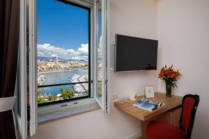 a room with a desk and a window with a view at Belvedere Luxury Rooms - Breathtaking View in Split