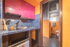 a kitchen with colorful cabinets and a sink at Quirinale Apartments in Rome +45 photos