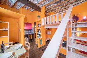 a kitchen and dining room with orange walls and a staircase at Quirinale Apartments in Rome