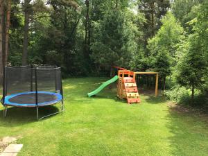 a yard with a playground with a slide and a play structure at Chata Dáša High Tatras in Mlynčeky