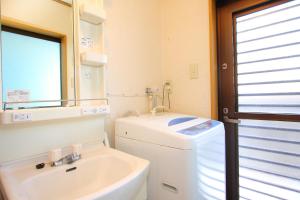 a bathroom with a sink and a toilet and a mirror at Yoshimura Tenjoan in Fujikawaguchiko +14 photos