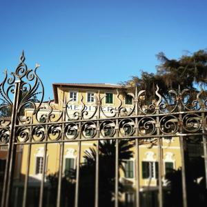 an ornate fence in front of a yellow building at Mediterraneo Emotional Hotel & Spa in Santa Margherita Ligure
