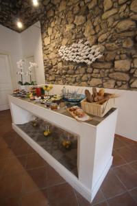 a wooden table topped with a vase filled with fruit at S'O Smart B&B Tropea in Tropea