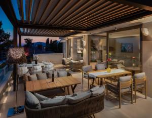 a patio with tables and chairs on a balcony at Alba Residence in Split