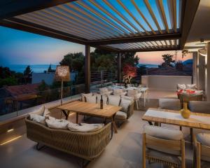 a patio with couches and tables on a roof at Alba Residence in Split