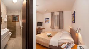 two pictures of a hotel room with a bed and a bathroom at Alba Residence in Split