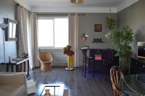 a living room with a person standing in front of a window at La douceur de Cassis in Cassis