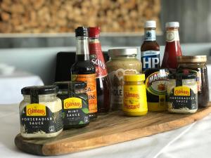 a wooden cutting board with different types of condiments at Hotel Staffler in Niederau