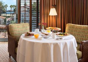 a table with food and drinks on it in a hotel room at Harbor View Inn in Santa Barbara