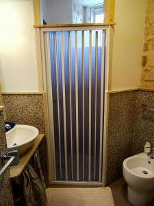 a bathroom with a shower and a toilet and a sink at La Dimora di Angela in Ragusa +51 photos