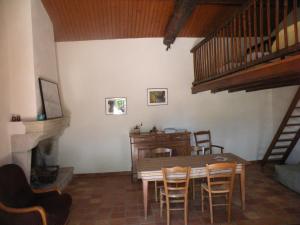 a dining room with a table and chairs and a staircase at la raymondiere in Vernoux-en-Gâtine