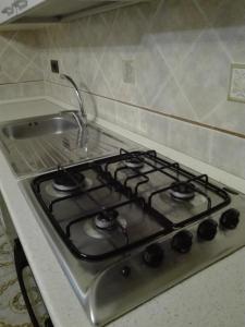 a stove top oven in a kitchen next to a sink at Casa Panoramica Vintage in Tramonti +17 photos