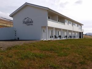 a white building with a sign on the side of it at Hafdals Hotel in Akureyri
