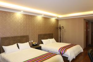 Rúm í herbergi á Hanshi Hotel Yanji
