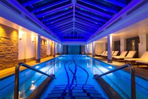 a swimming pool in a hotel with couches at Old Course Hotel St Andrews in St. Andrews