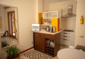 a small kitchen with a counter and a sink at Lalaland Apartment in Cagliari