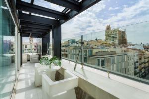 an apartment balcony with a view of a city at Room Mate Oscar, Madrid in Madrid