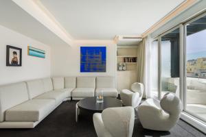 a living room with a couch and chairs and a table at Room Mate Oscar, Madrid in Madrid