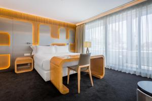 a hotel room with a bed and a desk at Room Mate Oscar, Madrid in Madrid
