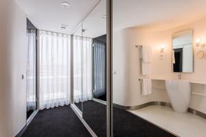 
a bathroom with a large mirror and a white tub at Room Mate Oscar in Madrid
