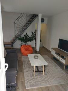 a living room with a couch and a table at Apartments Porat in Tivat