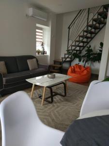 a living room with a couch and a coffee table at Apartments Porat in Tivat