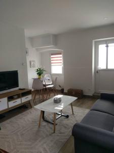 a living room with a couch and a coffee table at Apartments Porat in Tivat
