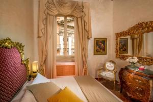 a bedroom with a bed and a window at Antica dimora navona in Rome