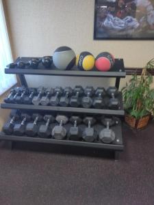 a shelf with dumbbells and balls in a room at Baymont by Wyndham Madison Heights Detroit Area in Madison Heights