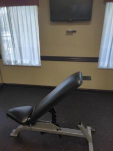 a black object on a treadmill in a room with windows at Baymont by Wyndham Madison Heights Detroit Area in Madison Heights