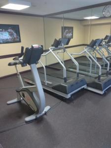 a gym with three treadmills and a treadmill at Baymont by Wyndham Madison Heights Detroit Area in Madison Heights