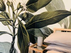 a bedroom with a mural of a plant on the wall at Camden Town Garden Cabin in London