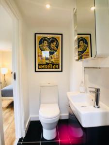 a bathroom with a toilet and a sink at Camden Town Garden Cabin in London